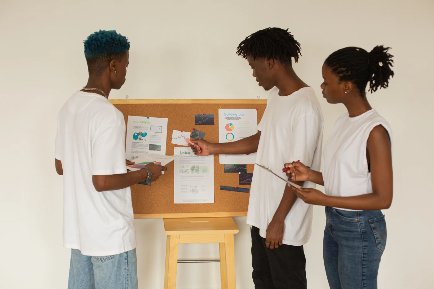 People discussing charts and research material on a planning board